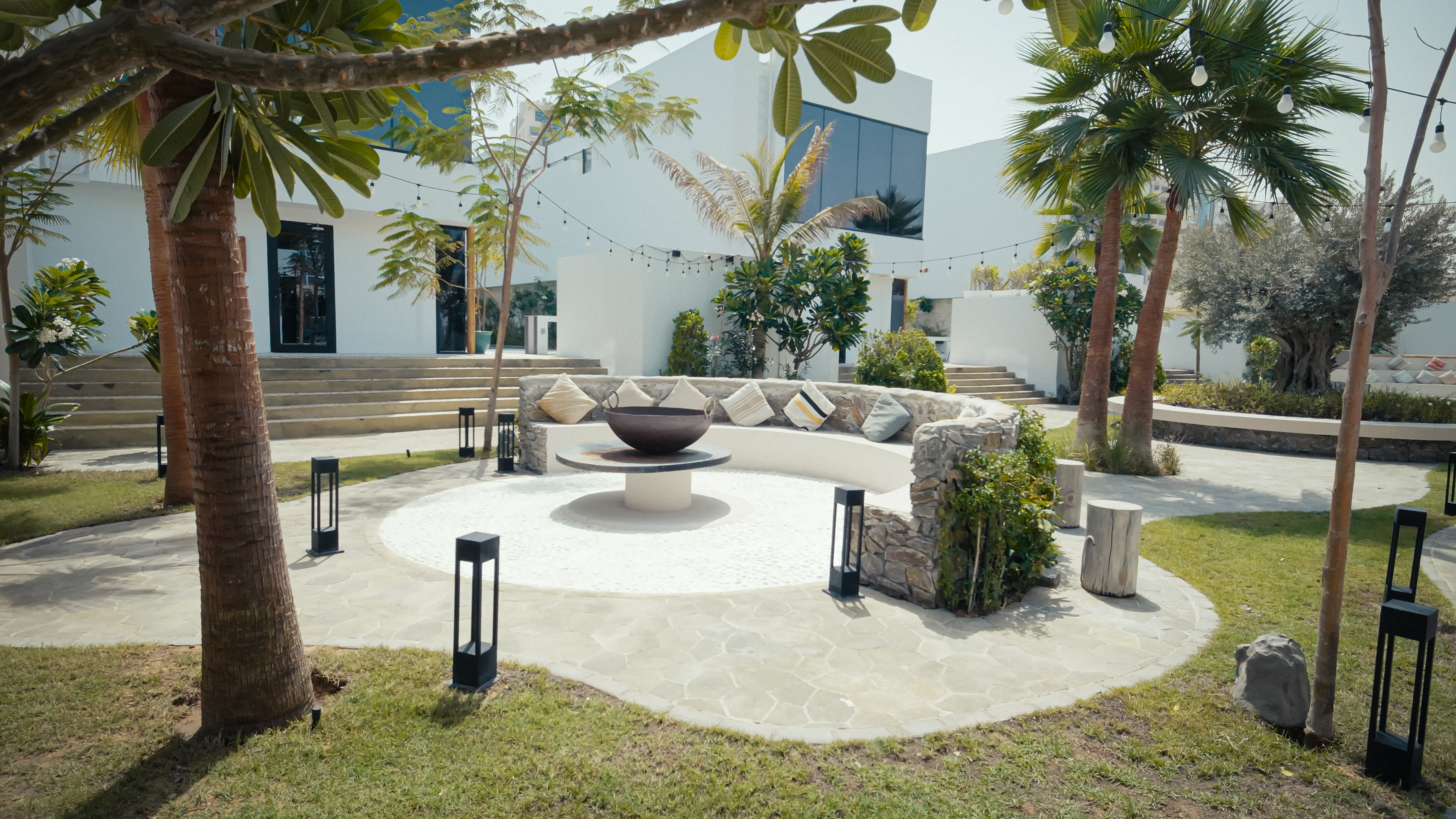 NAS House outdoor circular seating around a fire feature.