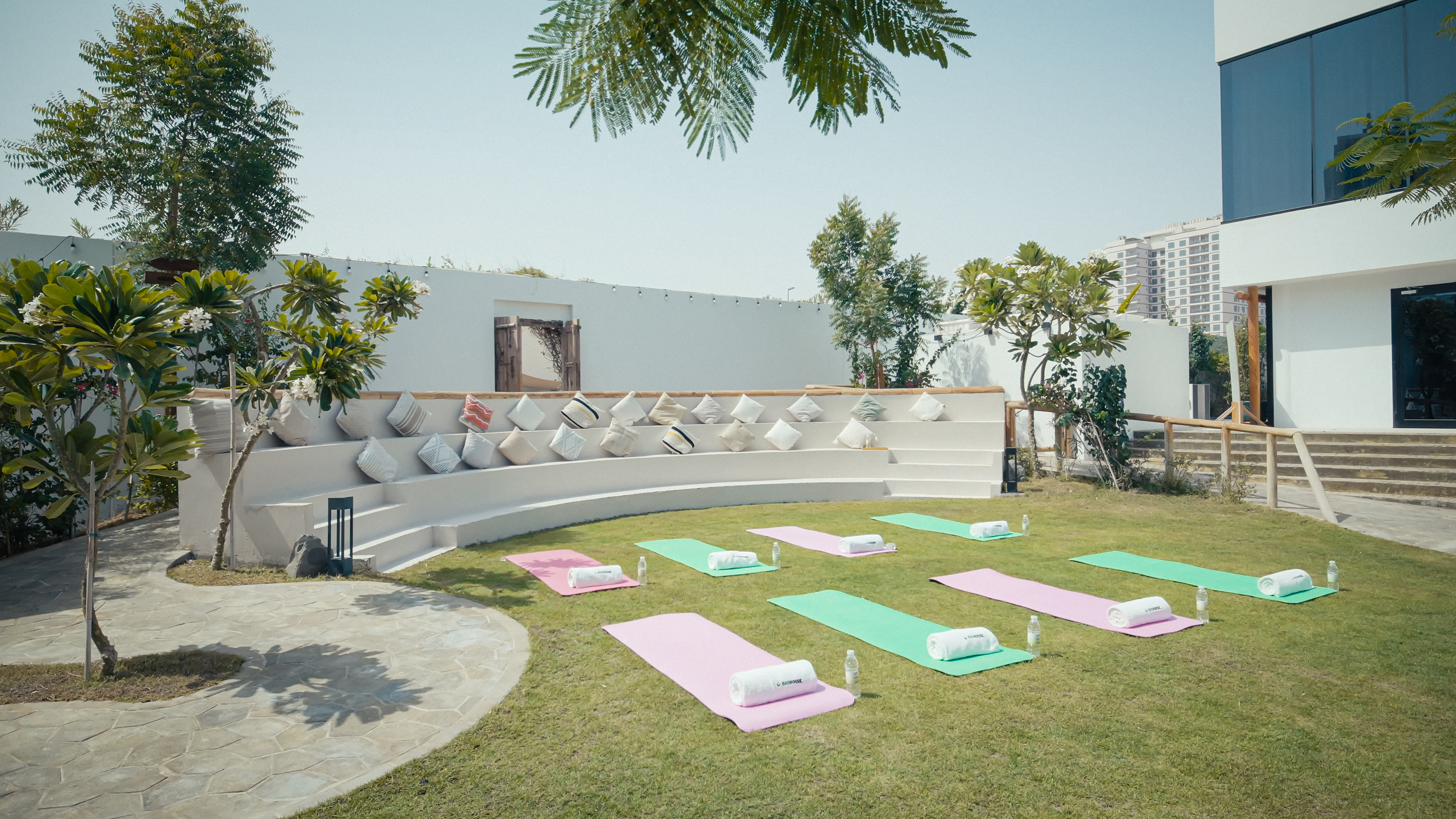 Garden wellness setup with yoga mats at NAS House.