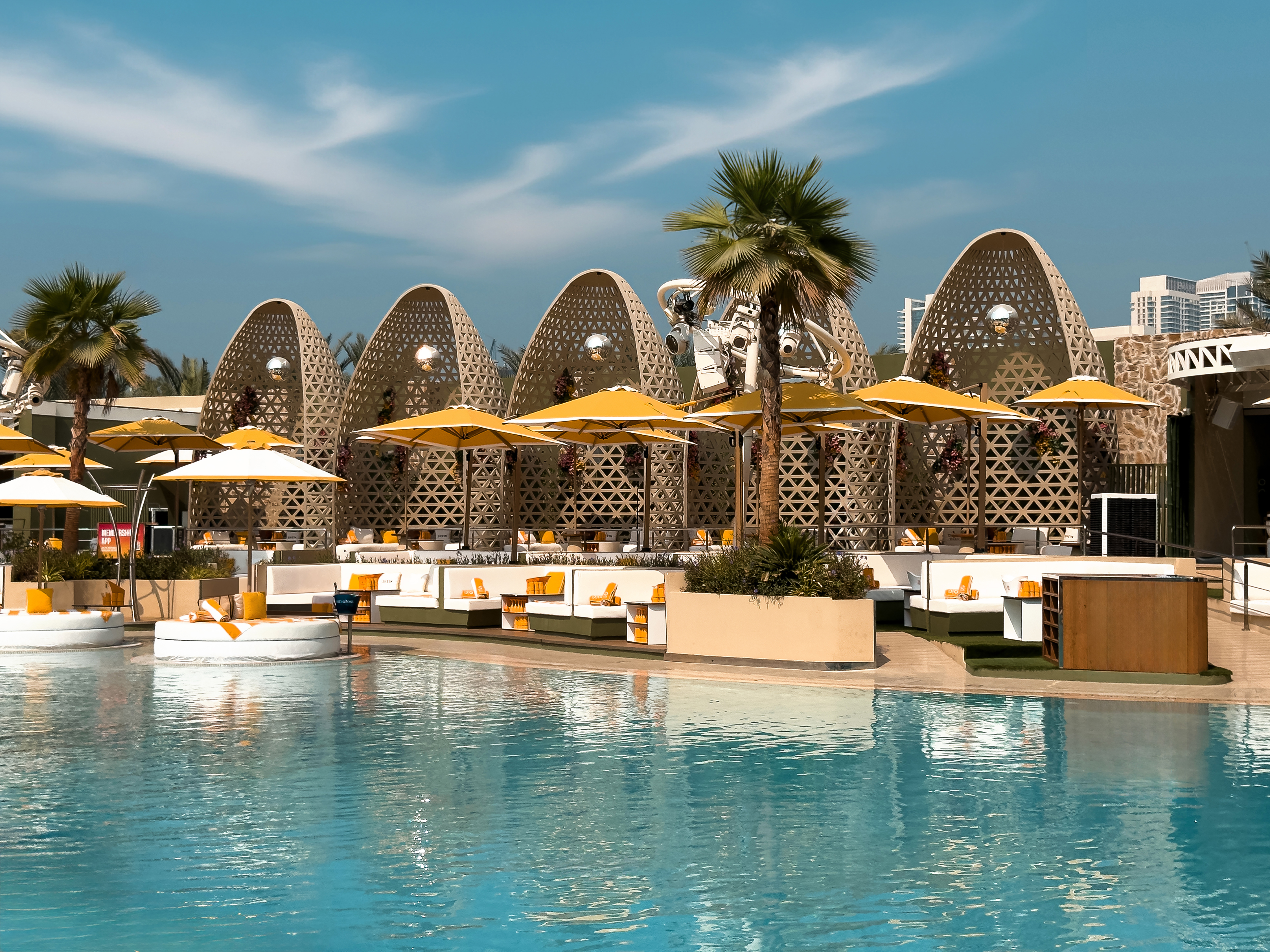 Poolside cabanas and umbrellas at O Beach Dubai.