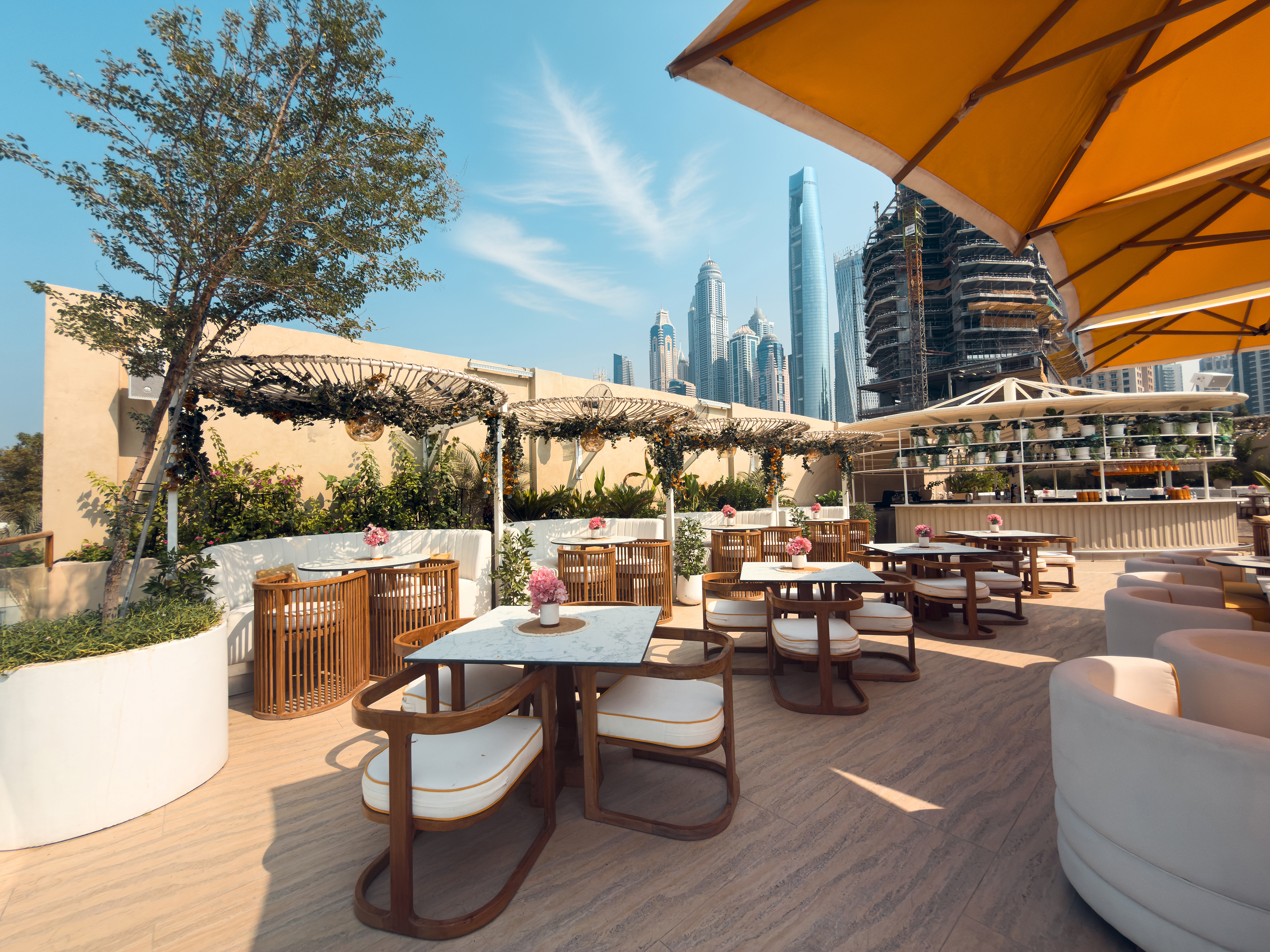 Outdoor dining area at O Beach Dubai with Dubai skyline views.